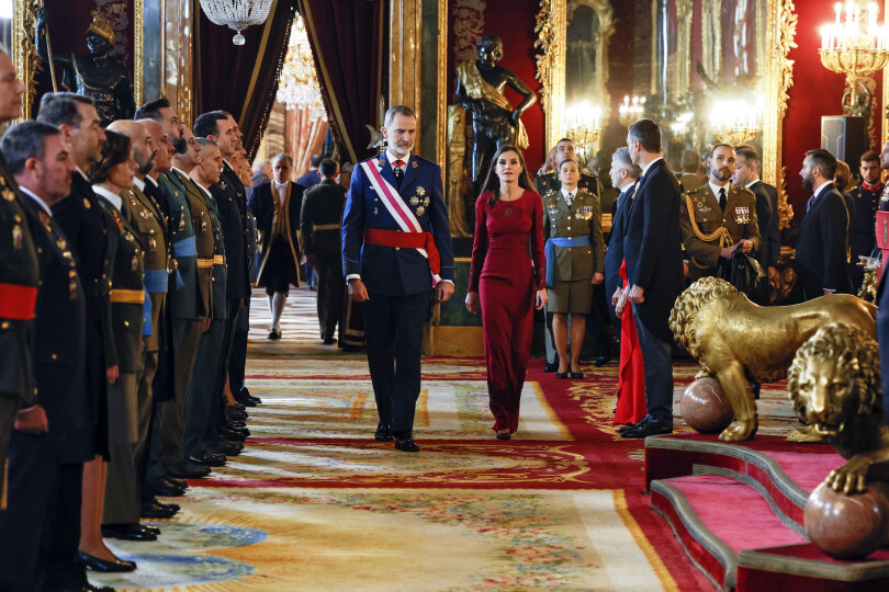 Le souverain arrive devant les lions de la salle du trône, en compagnie de la reine Letizia, superbe dans sa robe pourpre de Felipe Varela.